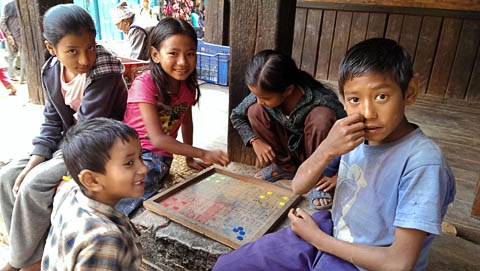 Kids playing pachisi on a Bhaktapur street corner