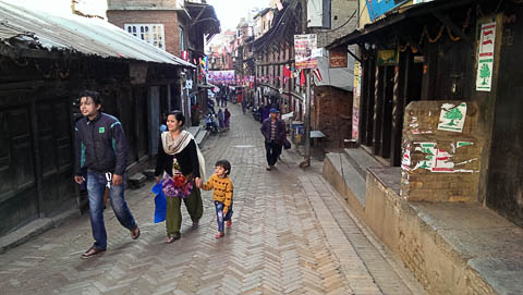 A family strolls down the street in Bhaktapur